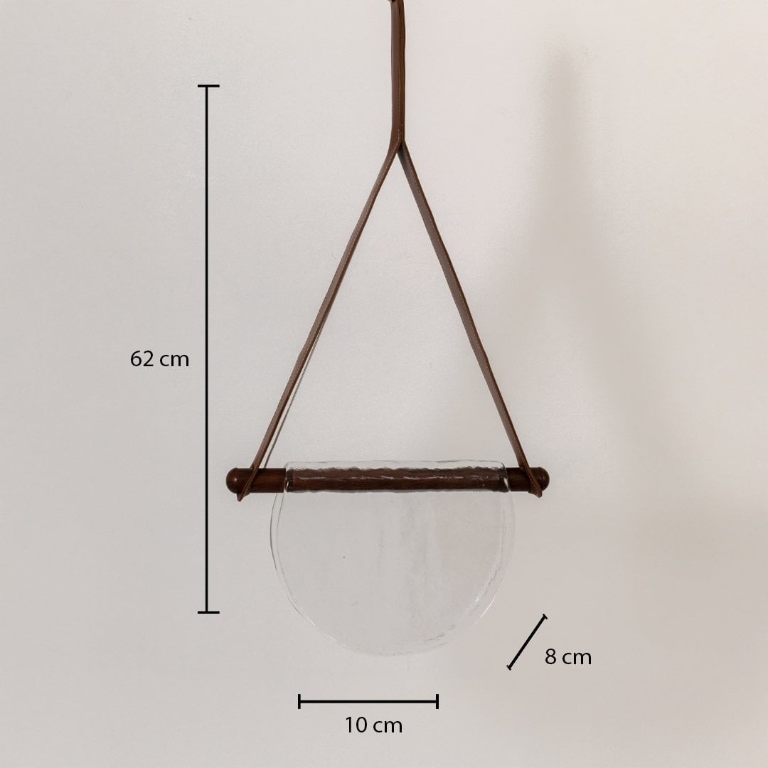 Pendant light with clear half-moon textured glass shade showing labeled dimensions: 62 cm height 10 cm width and 8 cm depth.