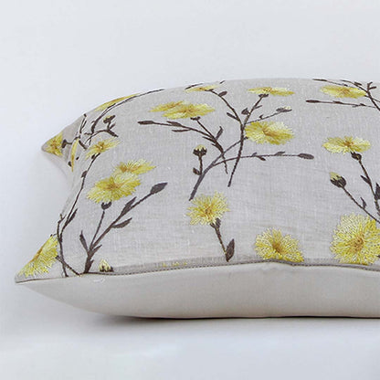 Beige cotton cushion cover with yellow floral embroidery shown in a rectangular shape enhancing home décor with a soft breathable and skin friendly handcrafted texture.