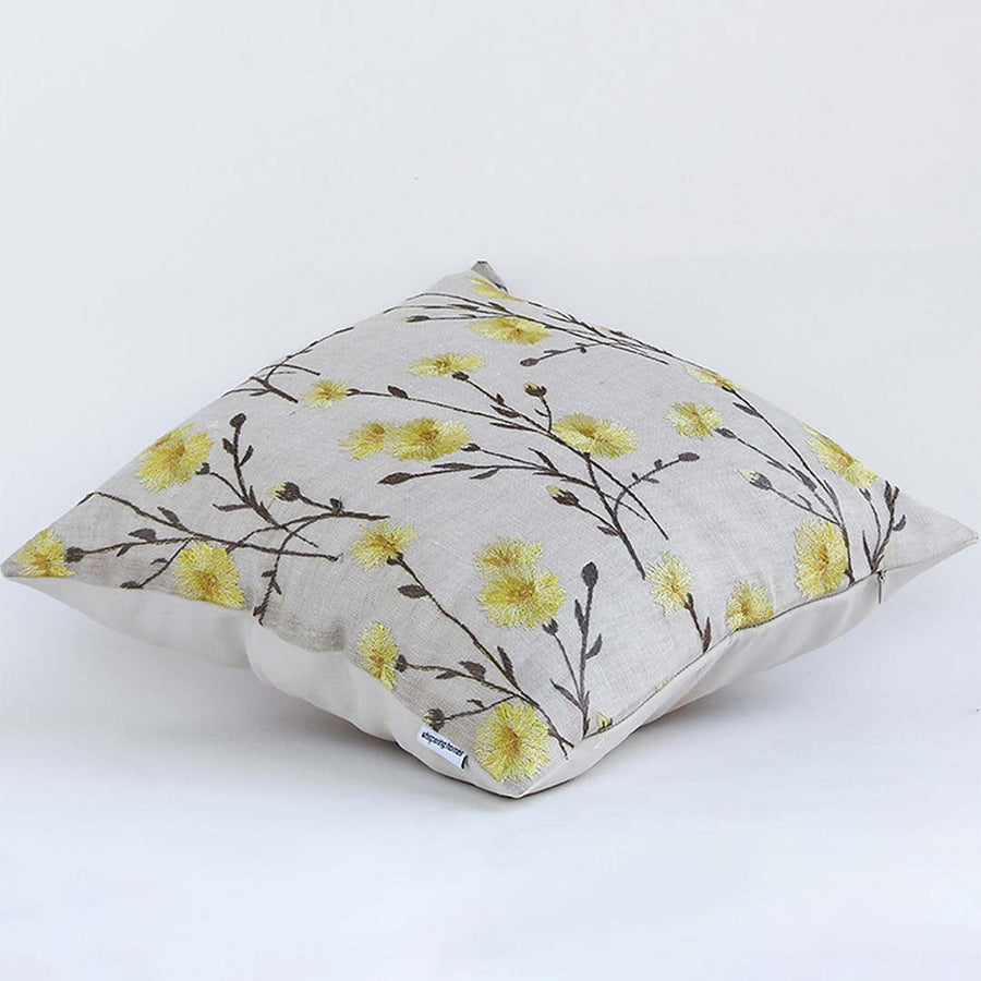 Beige cotton cushion cover with yellow floral vine embroidery offering a handcrafted design that adds warmth to home décor with a soft durable and skin friendly texture.