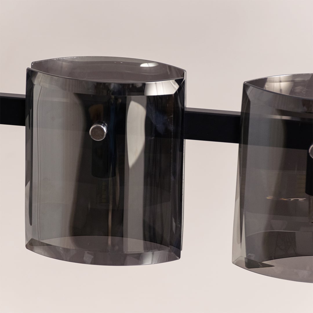 Closeup of black chandelier showing detailed smoked glass shades and metal frame for stylish contemporary interior lighting.