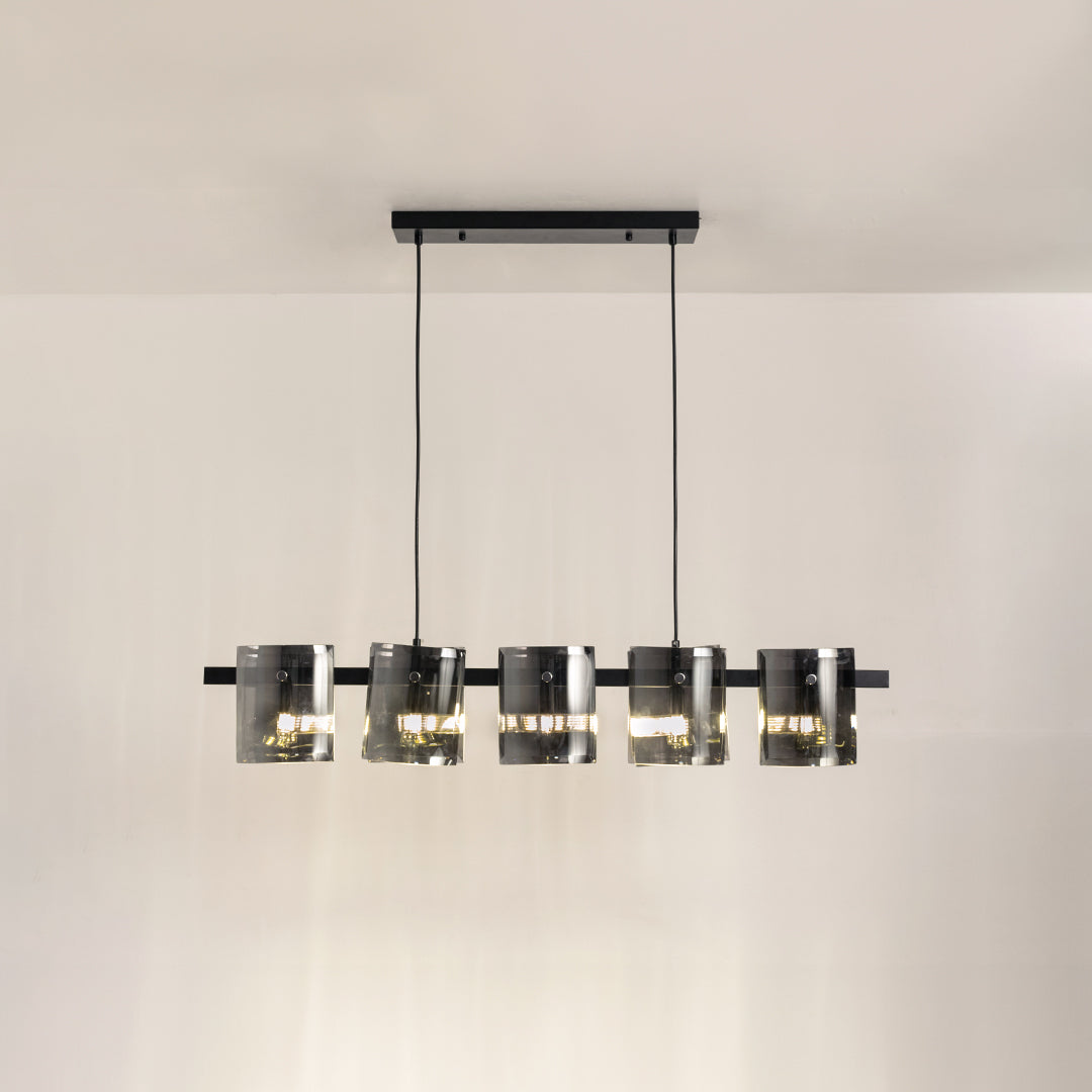 Black metal linear chandelier with smoked glass shades and integrated lighting creating sophisticated modern ceiling illumination.