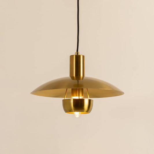 Gold metal pendant light with dome shade illuminated to showcase modern ceiling lighting and premium decorative appeal.