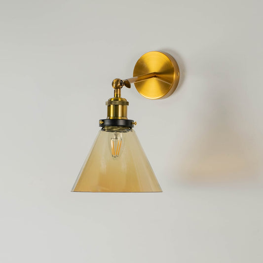 Gold wall mounted pendant light without illumination against a white background focusing on its elegant glass and metal design.