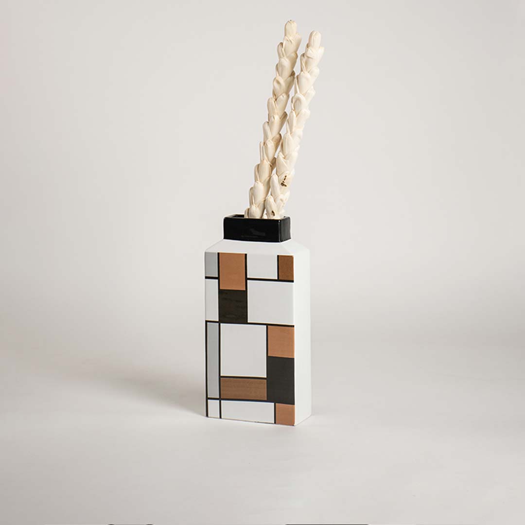 Contemporary ceramic vase with a graphic block pattern showcased on a crisp white background for clear visibility.