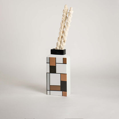 Contemporary ceramic vase with a graphic block pattern showcased on a crisp white background for clear visibility.