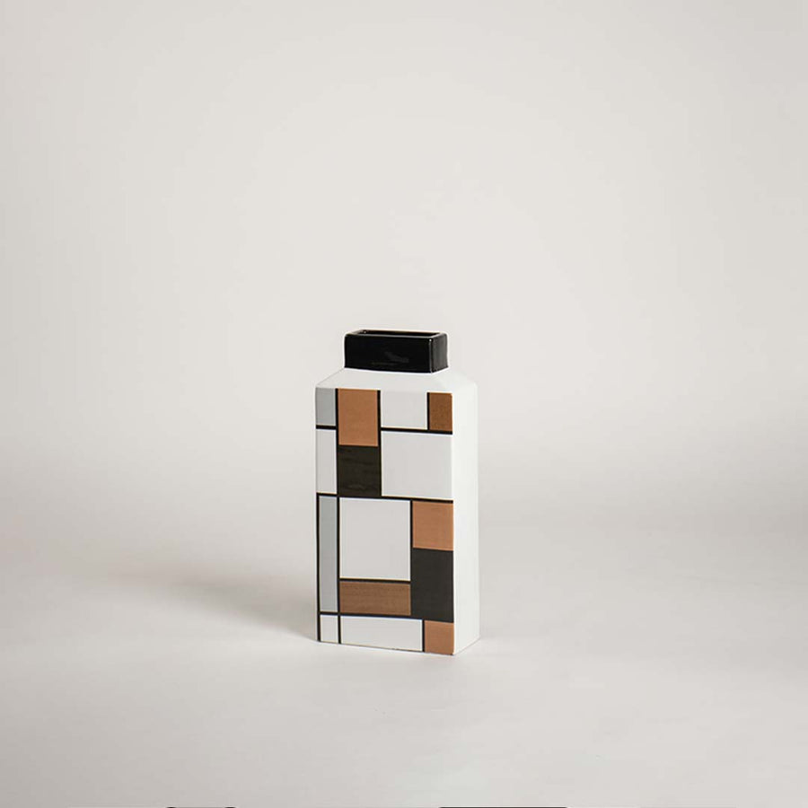 Modern rectangular ceramic vase with an abstract geometric block grid pattern on white background for artistic decor.