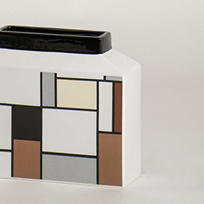 Closeup view of the geometric ceramic vase showing its multitone block pattern and smooth modern finish.