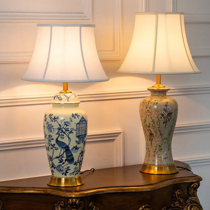 Set of ivory ceramic table lamps with blue floral and bird designs styled together for elegant interior lighting.