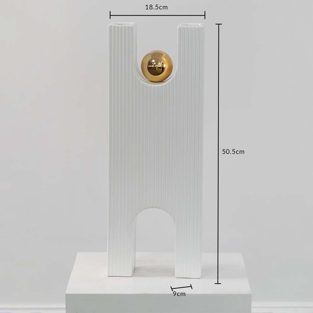 White ribbed sculpture with gold sphere shown with 50.5 cm height 18.5 cm width and 9 cm depth offering accurate size reference.