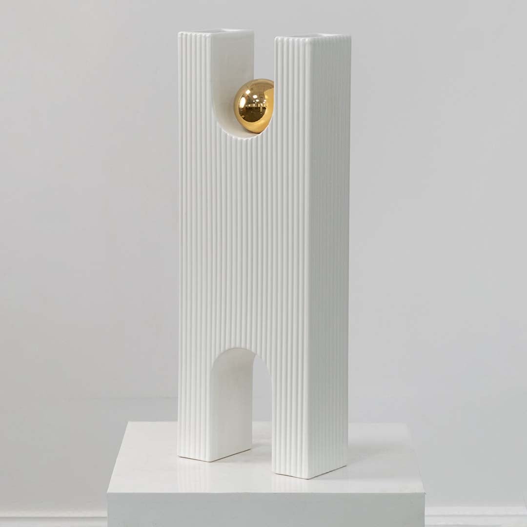 White textured decorative sculpture with gold sphere displayed on a clean white background highlighting its modern artistic form.