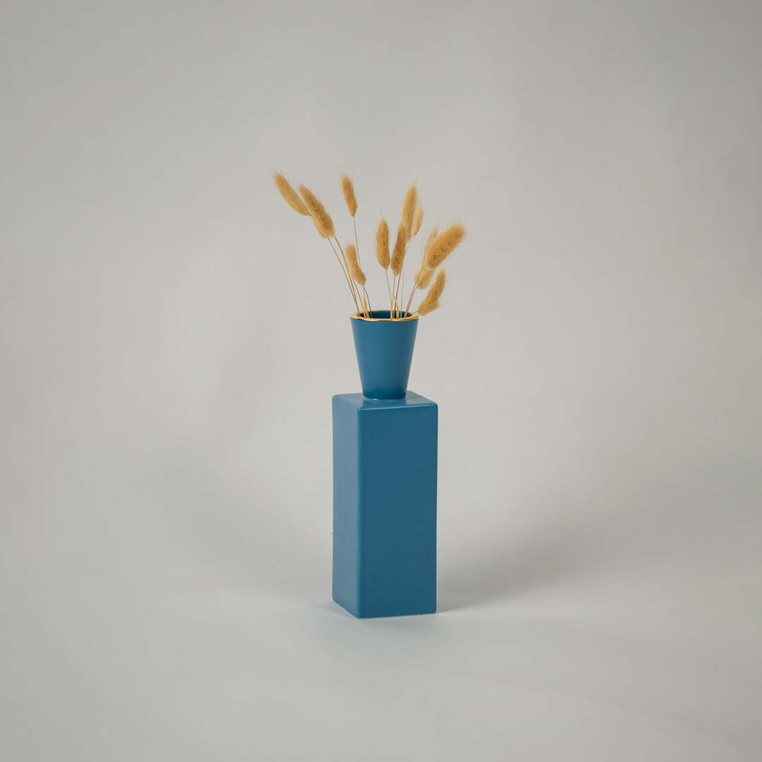 A blue geometric ceramic vase displayed on a plain white background  highlighting its tall rectangular body and clean modern minimalist design.