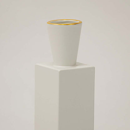 Closeup of white ceramic vase featuring a gold rim and smooth matte finish ideal for modern elegant home styling.