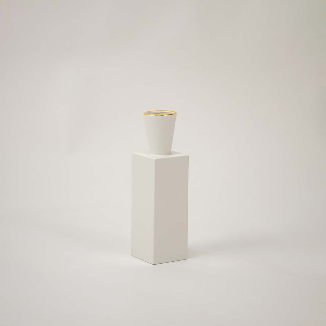 White ceramic geometric decorative vase with tall modern silhouette for tabletop styling and contemporary home decor.