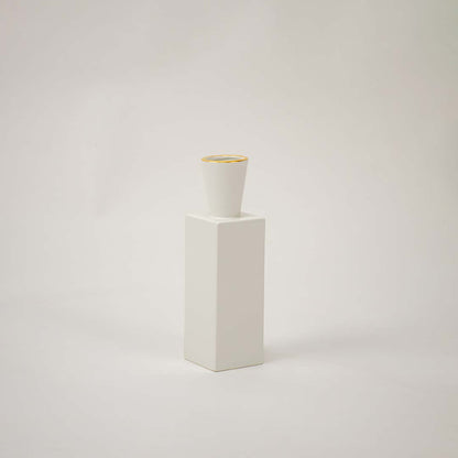 White ceramic geometric decorative vase with tall modern silhouette for tabletop styling and contemporary home decor.