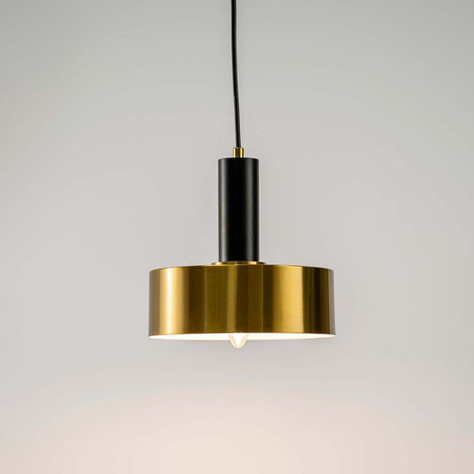 Black and brass metal pendant light with layered disc design for elegant contemporary home decor spaces.