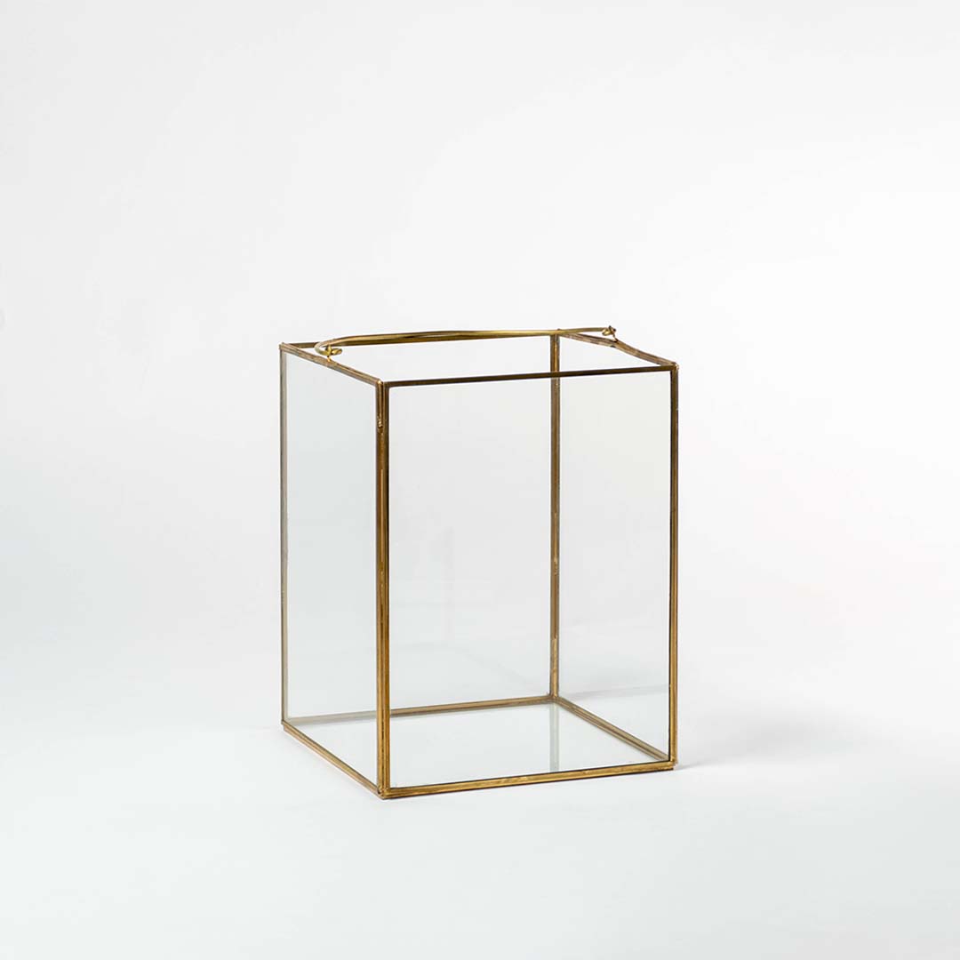 Cuboid decorative glass box with golden frame shown on white background perfect for stylish storage and modern interiors.