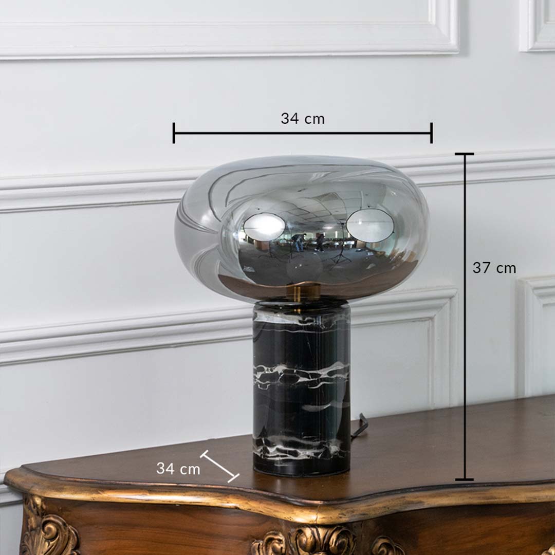 Smoked glass and black marble table lamp on white background showing height 37 cm and width 34 cm perfect for bedside or console styling.