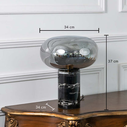 Smoked glass and black marble table lamp on white background showing height 37 cm and width 34 cm perfect for bedside or console styling.