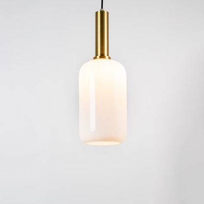 White glass pendant light with brass metal holder and minimalist cylindrical design for elegant ceiling lighting decor.