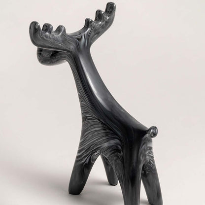 Black marble finish moose figurine displayed from side angle showing sculptural detail for modern home decoration.