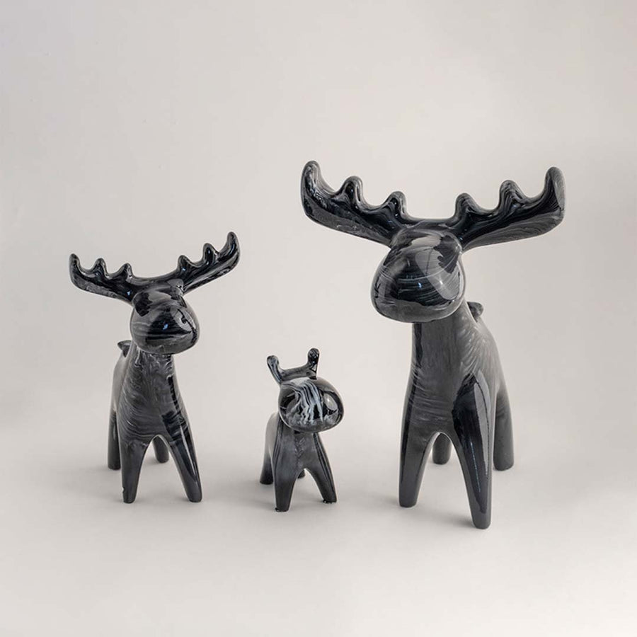 Grey decorative deer sculpture set with minimalist artistic design for contemporary shelf styling and home decor.