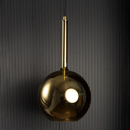 Amber pendant light softly light off black backdrop showcasing its smooth texture and warm illumination.