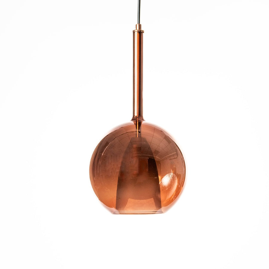 Amber pendant light radiating warm glow against white background highlighting the rich tone and texture of the glass shade.