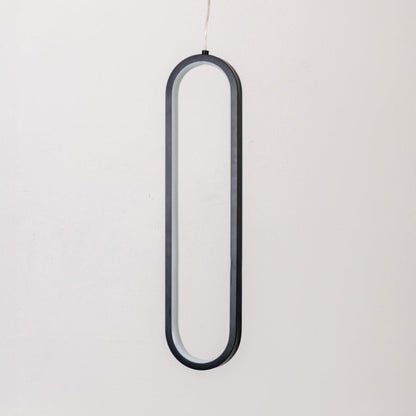 Modern metal elongated loop hanging light in black and white shown switched off on white background for minimal wall decor.