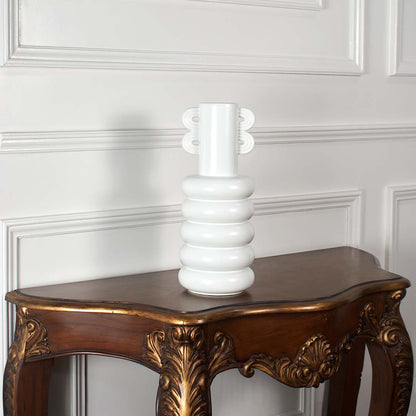 Modern white ceramic vase with sculpted rings and loop handle shown on a clean bright white background for stylish home decor.