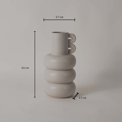 A sculptural neutral vase shown on a white background with clear dimension markings displaying 33 cm height 17 cm top width and 17 cm base width.