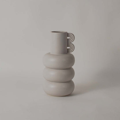 A sculptural neutral vase shown on a white background with measurements displaying 33 cm height 17 cm width and 17 cm base size for accurate dimension reference.