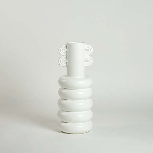 White ceramic vase with loop handle and ring base shown on a clean white background for modern minimalist home decor.
