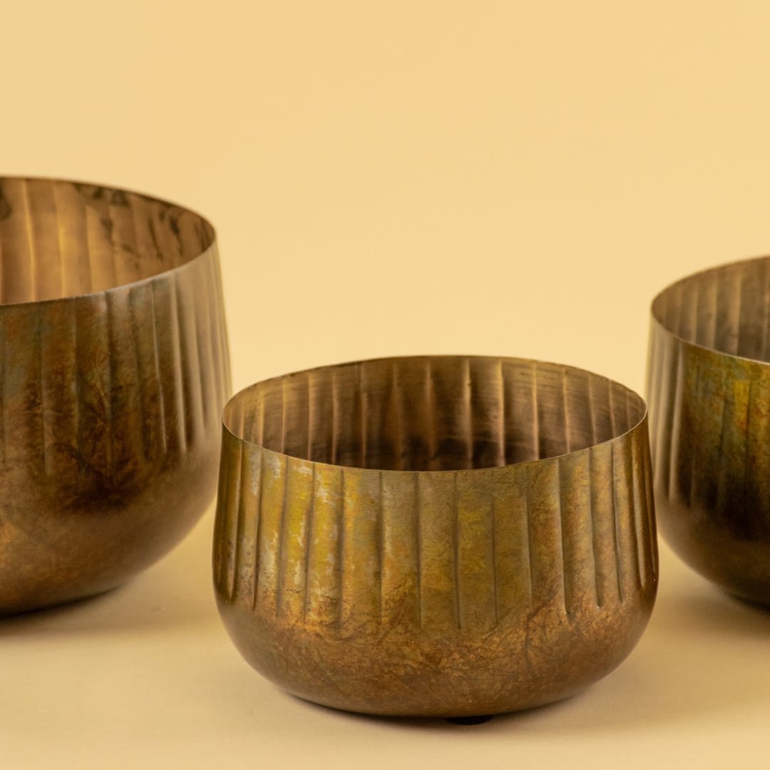 Bronze ribbed metal bowl planter closeup showing textured finish perfect for shelves tables and natural modern decor.