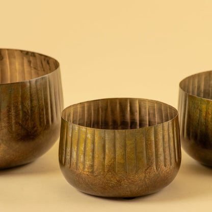 Bronze ribbed metal bowl planter closeup showing textured finish perfect for shelves tables and natural modern decor.