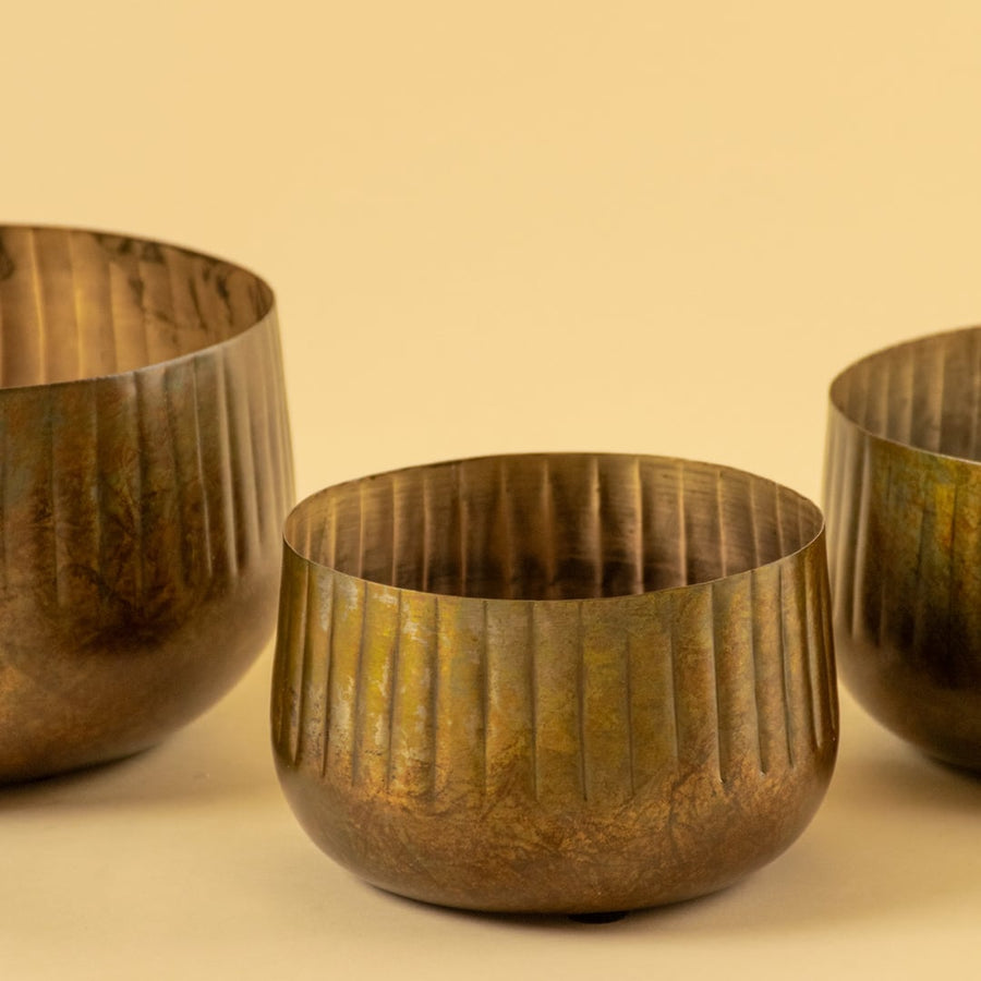 Bronze ribbed metal bowl planter closeup showing textured finish perfect for shelves tables and natural modern decor.