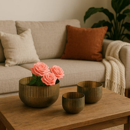 Bronze ribbed bowl planter styled in a warm modern space adding a soft rustic accent to shelves tables and decor corners.