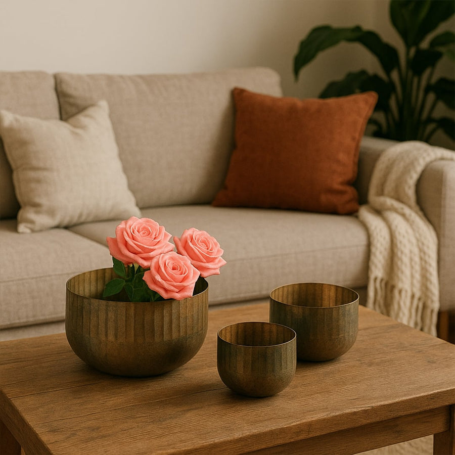 Ribbed metal bowl planter styled in a warm modern space adding a rustic touch to shelves and decor corners.