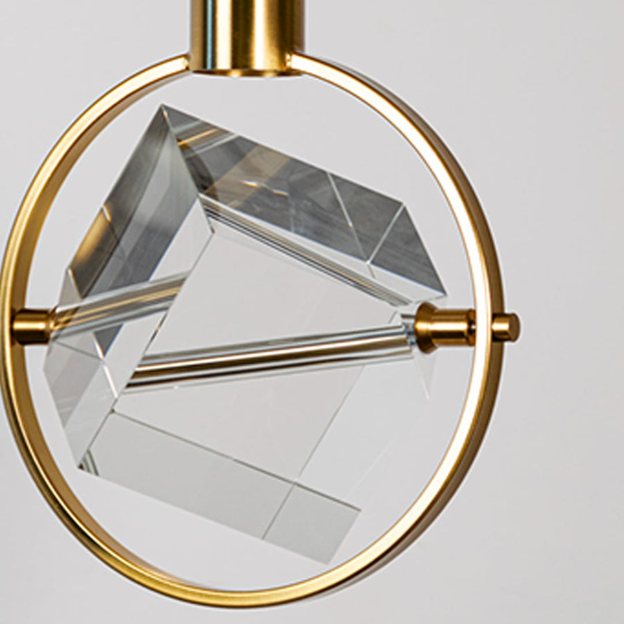 Closeup of crystal pendant light with golden circular frame and cube design perfect for luxury modern interiors.