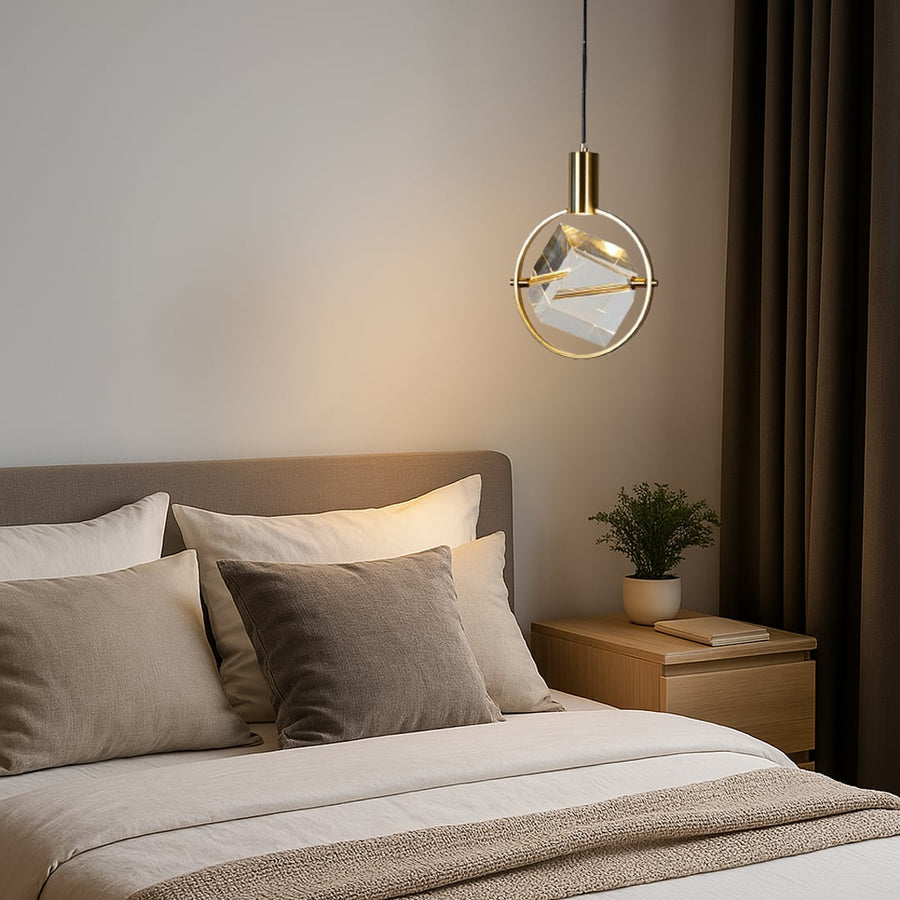 Crystal pendant light with golden frame styled in modern bedroom above bedside table for elegant home lighting.