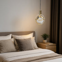 Modern pendant light beside bed adding warm ambient lighting and contemporary elegance to bedroom decor.