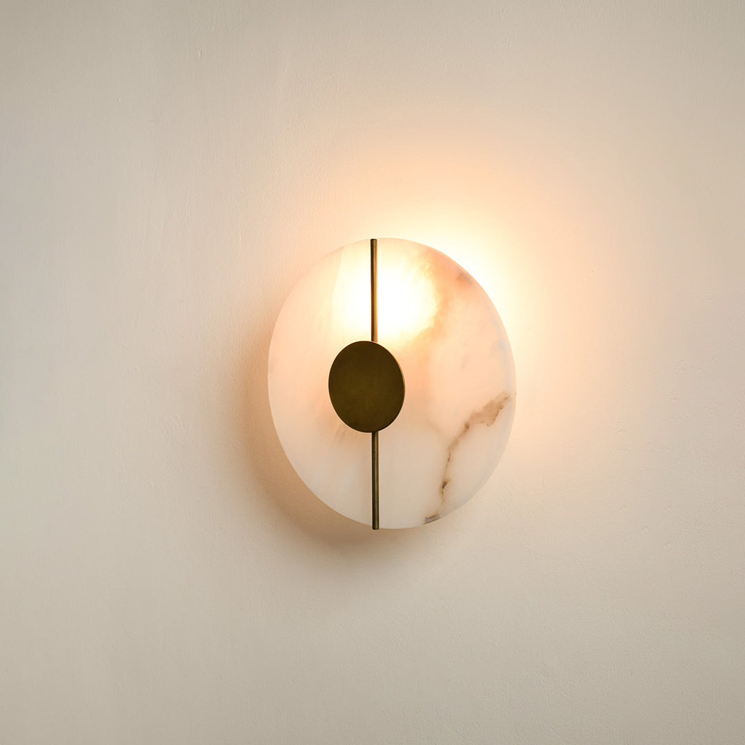 Modern marble wall light with warm ambient glow for stylish bedroom and premium decor styling spaces.

