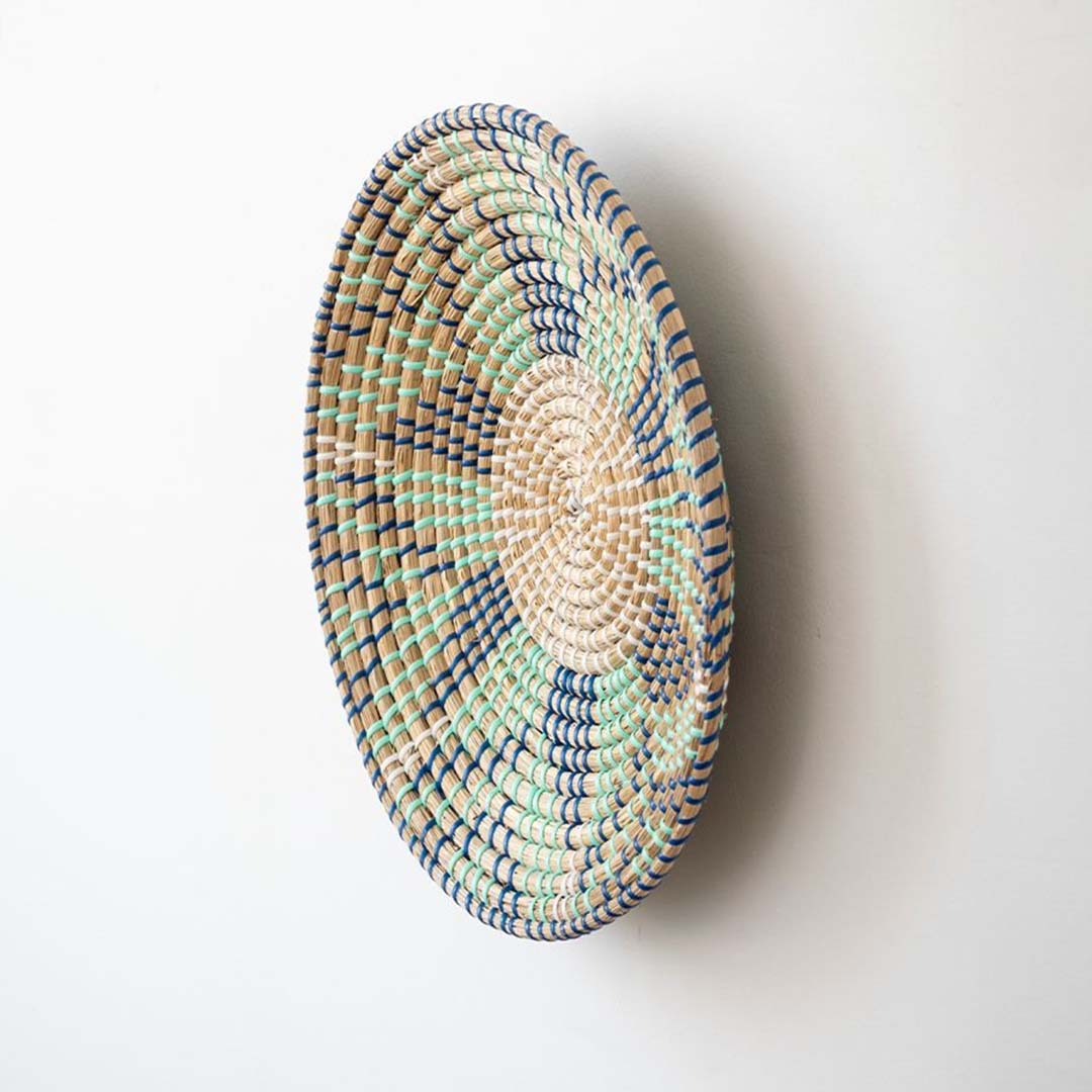 Handwoven wicker wall plate side view showing beige green and navy woven texture for stylish boho wall decor.
