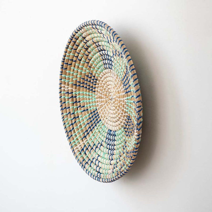 Handwoven wicker wall plate side view showing beige green and navy woven texture for stylish boho wall decor.