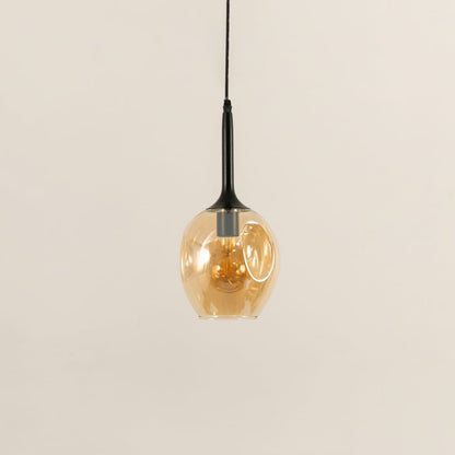 Amber glass pendant light turned off on white background for modern decor styling.
