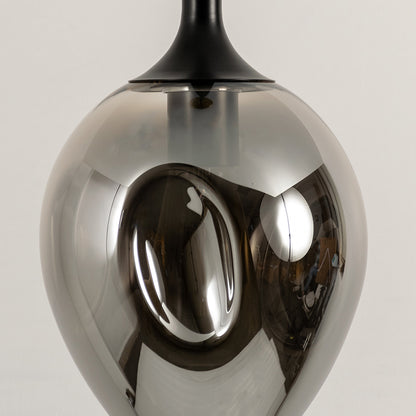 Close up chrome pendant light with reflective metallic finish modern decorative hanging light for contemporary interiors.