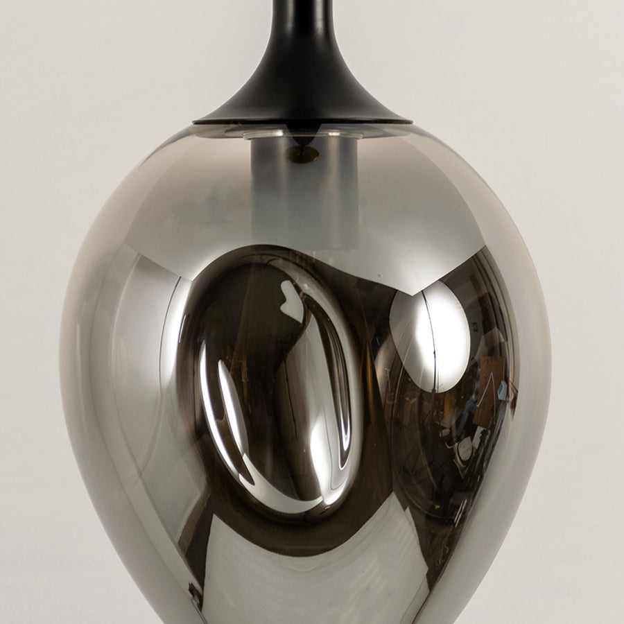Close up chrome pendant light with reflective metallic finish modern decorative hanging light for contemporary interiors.