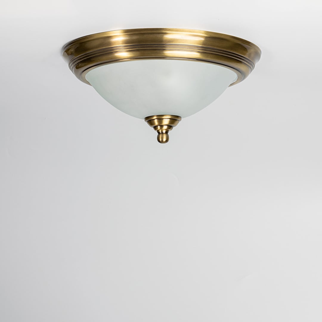 Modern antique brass ceiling light with frosted glass diffuser for stylish bedroom and traditional home decor spaces.