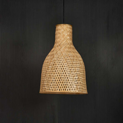Rattan pendant light with tall tapered handwoven bamboo shade turned off against plain black background.