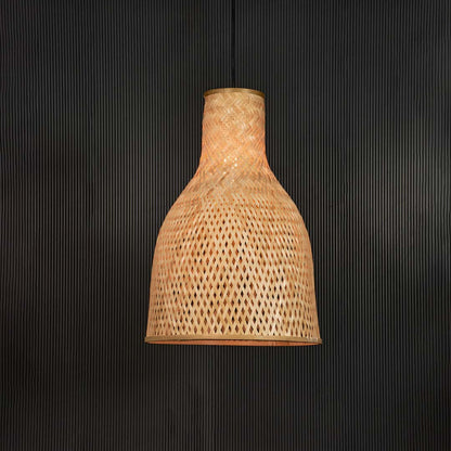 Tall rattan pendant light with handwoven bamboo shade turned on glowing softly against plain black background.