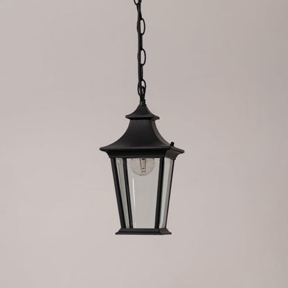 Black metal hanging lantern with clear glass panels displayed on a white background with the light switched off.